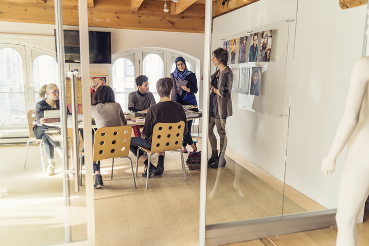 Meeting in small creative start-up enterprise lead by woman.